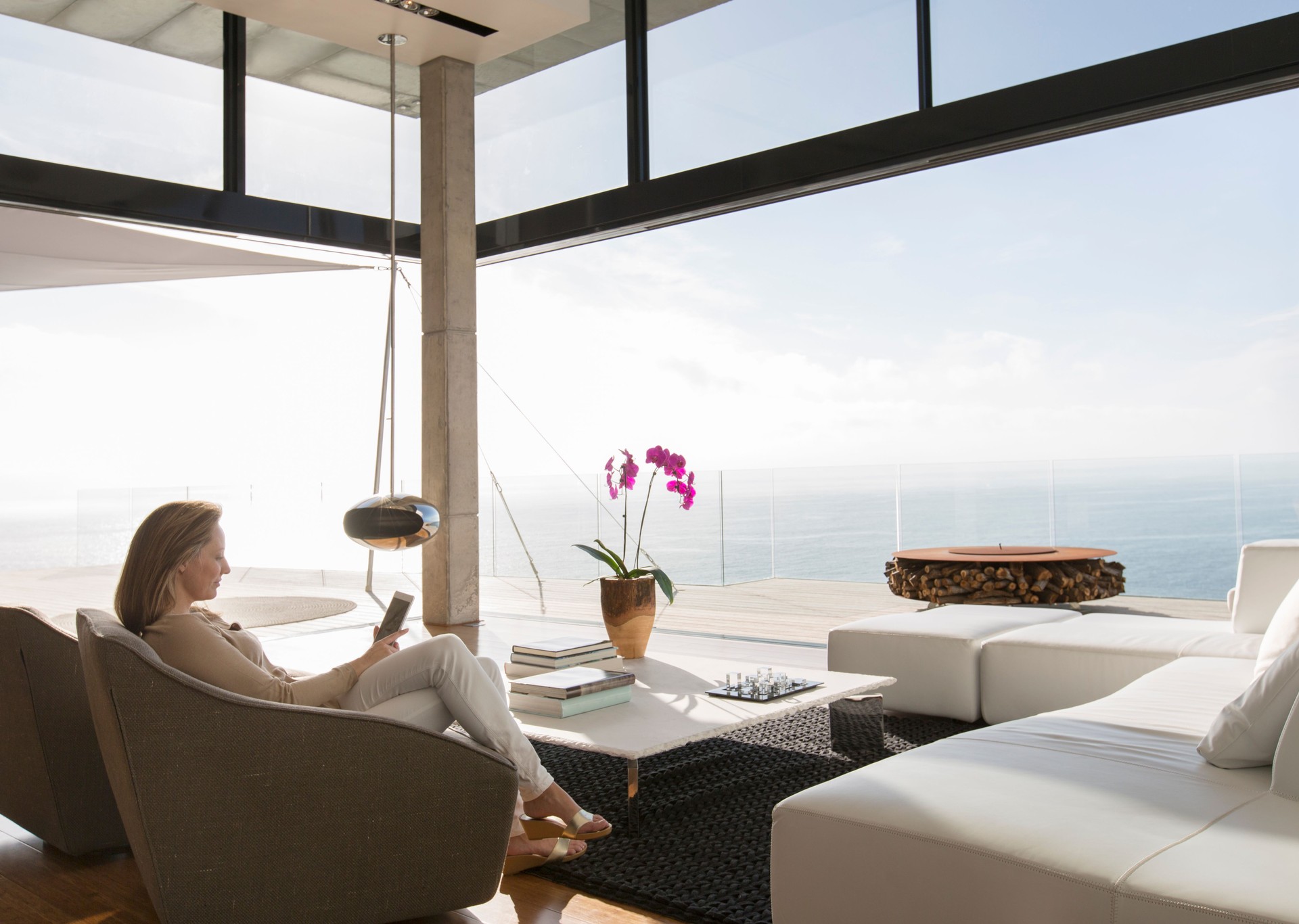 Woman using cell phone in modern living room